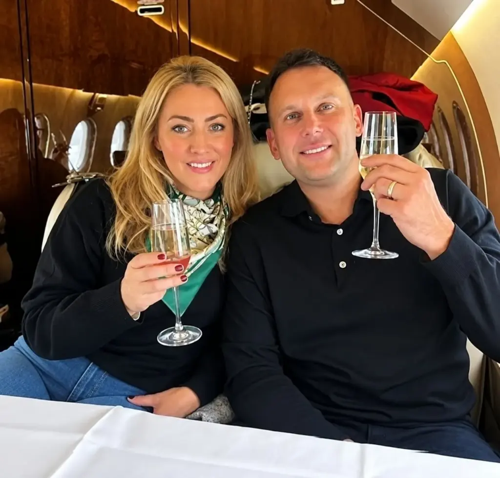 Robert and Kayleigh of Shaw Luxury Real Estate seated together on a private jet